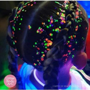 little girl with neon glitter in her hair