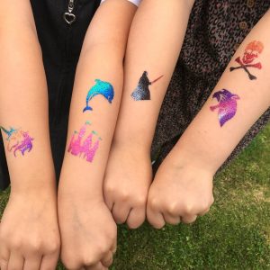Glitter Tattoos, kids with colourful temporary tattoos on their arms